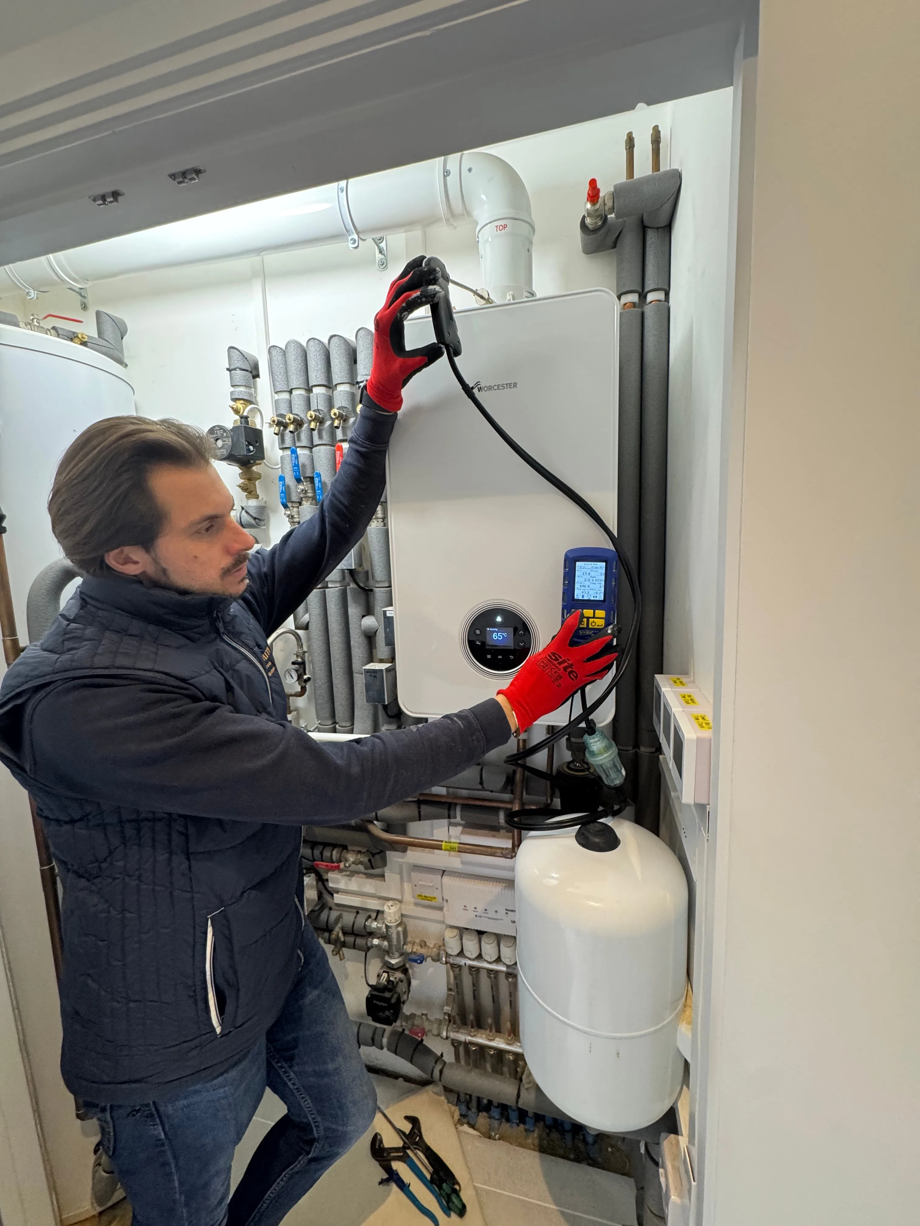 Shoosmith engineer carrying out a safety check on a Worcester Bosch boiler installation